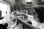 A graduate student performs an experiment in one of Nova University Oceanographic Center's laboratory, 1970